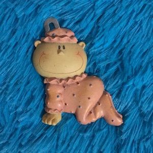 Hang on wall decor of a baby in pink clothes